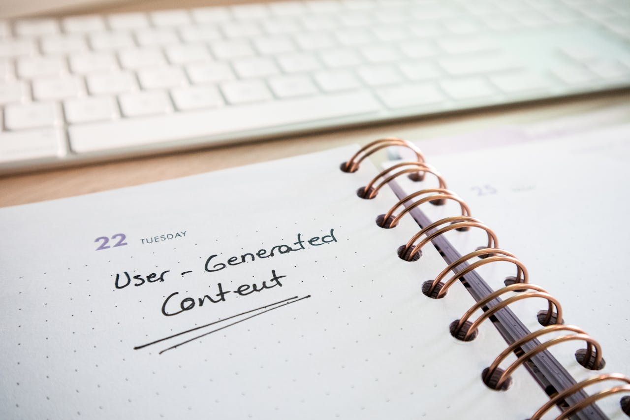 home-hero-bg Notebook with user-generated content note and keyboard, ideal for planning and productivity.